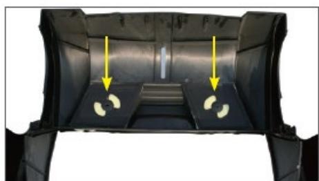 Interior view of a car cab with two yellow arrows pointing to the side panels (no text or symbols visible)