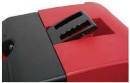 Close-up of a red and black electronic device with a black handle (no visible text or symbols)