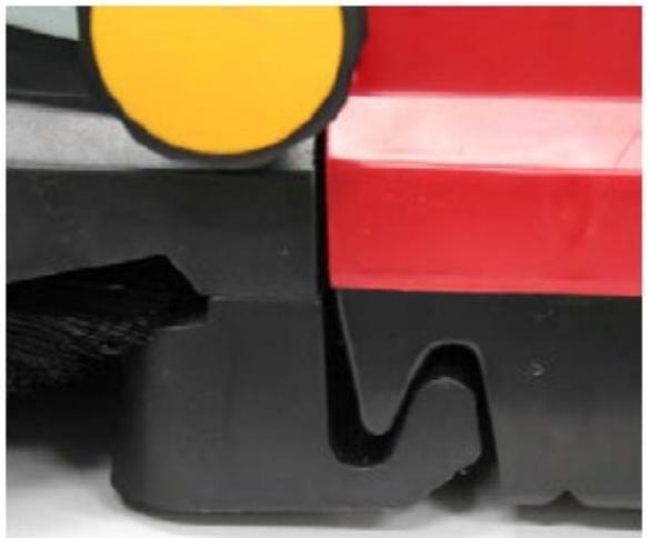 Close-up of a mechanical component with black, red, and yellow components (no visible text or symbols)