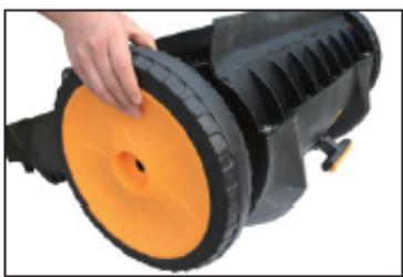 Close-up of a hand holding a black and orange industrial hose component (no text or symbols visible)