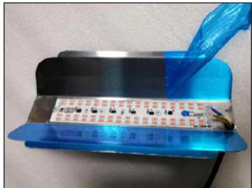 Close-up of a flexible electronic component with blue filament and wires, no visible text or symbols