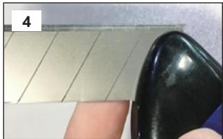 Close-up of a finger pressing down on a tiled surface with a black contact pad (no text or symbols visible)