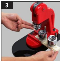 Close-up of hands operating a red microscope with mechanical parts (no visible text or symbols)