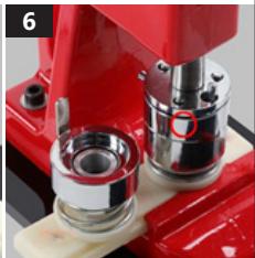 Close-up of a red mechanical device with metallic components and a circular annotation (no visible text or symbols)