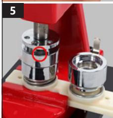 Close-up of a mechanical assembly with metallic components and a red base (no visible text or symbols)