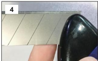 Close-up of a finger pressing down on a tiled surface with a black contact pad (no text or symbols visible)