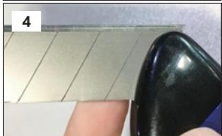 Close-up of a finger pressing down on a tiled surface with a black contact pad (no text or symbols visible)