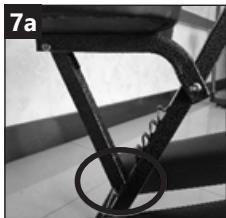 Close-up of a bicycle seat frame with a circular weight marker (no text or symbols visible)