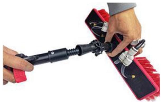 Close-up of hands using a tool to adjust or install a red and black electronic device (no visible text or symbols)
