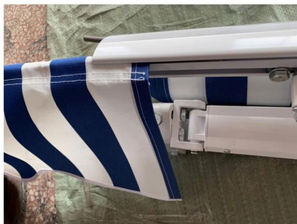 Close-up of a striped fabric or towel rack with blue and white stripes, placed on a textured surface (no visible text or symbols)