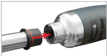 Close-up of a black and silver connector with a red arrow pointing to a threaded end (no text or symbols visible)