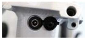 Close-up of mechanical components with circular and rectangular features (no visible text or symbols)