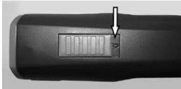 Close-up of a black cylindrical device with a rectangular slot and an arrow pointing to it, no visible text or symbols.