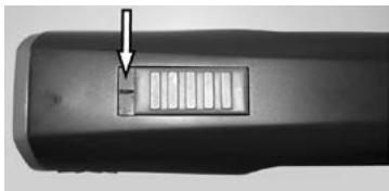 Close-up of a black cylindrical object with a small rectangular slot and an arrow pointing to it (no text or symbols visible)