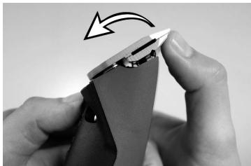 Close-up of hands holding a small electronic component with a lightning bolt indicating rotation (no text or symbols visible)