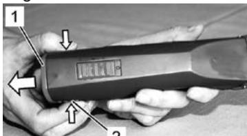 Hand holding a handheld device with labeled parts and arrows indicating movement or change