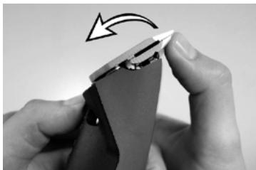 Close-up of hands holding a small object with a curved arrow indicating rotation (no text or symbols visible)
