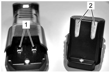 Close-up of two black electrical connectors with labeled parts (1 and 2), no visible text or symbols beyond labels